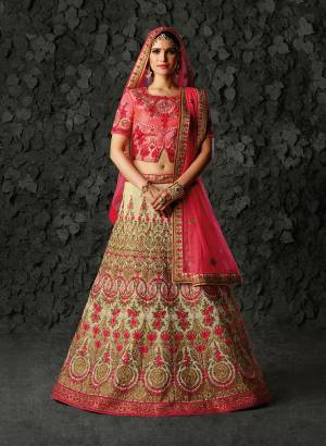 You Will Definitely Earn Lots Of Compliments Wearing This Heavy Designer Lehenga Choli In Pink Colored Blouse And Dupatta Paired With Cream Colored Lehenga. it is Rich Silk Based Paired With Net Fabricated Dupatta. 