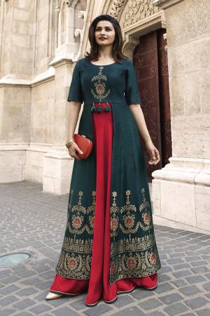 New Shade In Blue Is Here With This Designer Readymade Long Kurti In Prussian Blue And Red Color. It Has New And Different Cuts At The Front. It Is Fabricated On Jacquard Silk And Satin. Buy Now.