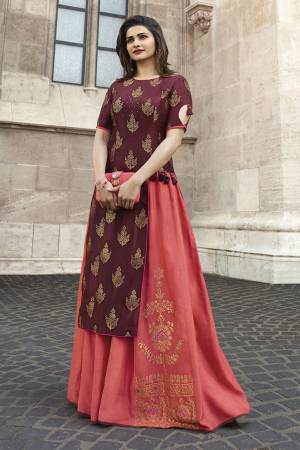 Asymetric Patterned Designer Readymade Long Kurti IS Here In Maroon And Peach Color. This Kurti Is Fabricated On Jacquard Silk And Satin. It Is Beautified With Weave, Stone Work And Tassels. 