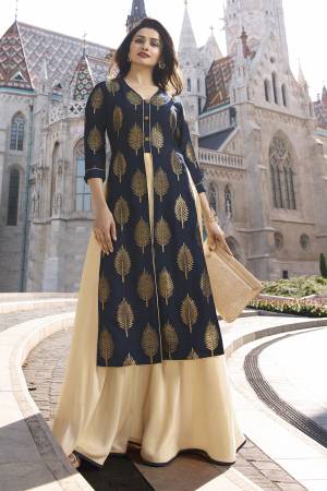 Enhance Your Personality Wearing This Designer Readymade Kurti In Navy Blue And Cream. It Is Fabricated On Jacquard Silk And Satin Beautified With Weave And Stone Work. Its Rich Color And Fabric Will Earn You Lots Of Compliments From Onlookers. 