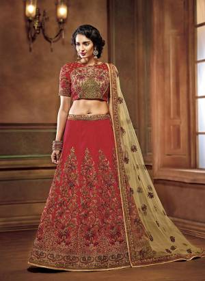 Here Is A Royal Looking, Heavy Designer Lehenga Choli In Maroon Color Paired With Beige Colored Dupatta. Its Blouse And Lehenga Are Art Slk Based Paired With Net Fabricated Dupatta. It Is Beautified With Thread & Jari Embroidery With Stone Work. 