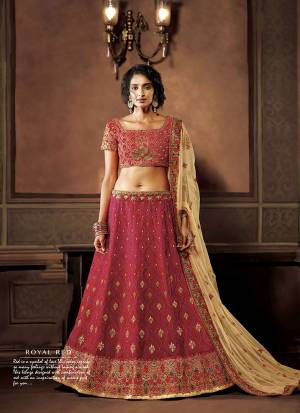 Here Is A Royal Looking, Heavy Designer Lehenga Choli In Dark Pink Color Paired With Cream Colored Dupatta. Its Blouse And Lehenga Are Art Slk Based Paired With Net Fabricated Dupatta. It Is Beautified With Thread & Jari Embroidery With Stone Work. 