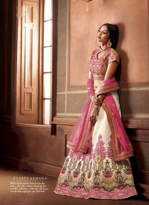 New and Unqiue Color Pallete IS Here With This Heavy Designer Lehenga Choli In Peach Colored Blouse paired With White Colored Lehenga And Pink Colored Dupatta. It Is Fabricated On Art Silk Paired With Net Fabricated Dupatta. Buy This Now.