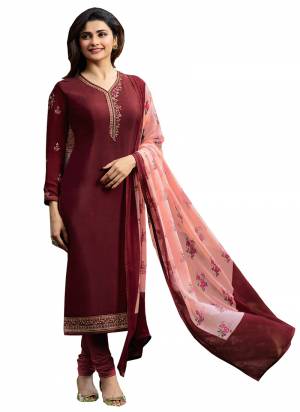 For A Rich And Elegant Look, Grab This Designer Straight Suit In Maroon Color Paired With Contrasting Peach Colored Dupatta. Its Top And bottom Are Crepe Based Paired With Chiffon Dupatta. Get This Stitched As Per Your Desired Fit And Comfort. 