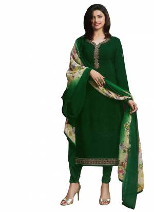 Bright And Appealing Color Is Here With This Designer Semi-Stitched Suit In Dark Green Color Paired With Cream And Multi Colored Dupatta. Its Top And Bottom Are Crepe Fabricated Paired With Chiffon Dupatta. It Has Prints And Embroidery giving It An Attractive Look. 