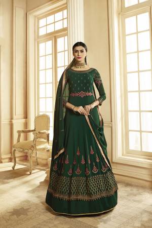 Grab This Very Pretty, Designer Floor Length Suit In Dark Green Color. This Pretty Suit Is Georgette Based Paired With Santoon Bottom And Georgette Dupatta. It Is Beautified With Attractive Embroidery. 