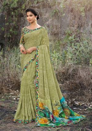 Grab This Very Pretty Saree In Light Green Color Paired With Green Colored Blouse. This Saree And Blouse Are Fabricated On Satin Georgette Beautified With Prints All Over It. 
