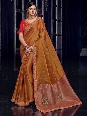 Attractively Gorgeous mesmerizing is what you will look at the next wedding gala wearing this beautiful Rust orange color silk fabrics saree. Ideal for party, festive & social gatherings. this gorgeous saree featuring a beautiful mix of designs. Its attractive color and designer heavy embroidered design, Flower patch design, zari resham work, stone design, beautiful floral design work over the attire & contrast hemline adds to the look. Comes along with a contrast unstitched blouse.