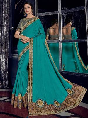Get this amazing saree  and look pretty like never before. wearing this Turquoise Blue color two tone silk fabrics saree. Ideal for party, festive & social gatherings. this gorgeous saree featuring a beautiful mix of designs. Its attractive color and designer heavy embroidered design, Flower patch design, zari resham work, stone design, beautiful floral design work over the attire & contrast hemline adds to the look. Comes along with a contrast unstitched blouse.