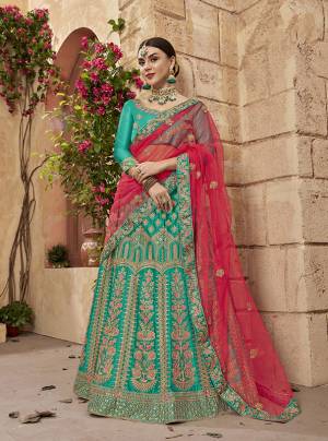 New Color Pallete Is Here With This Heavy Designer Lehenga Choli In Turquoise Blue Color Paired With Contrasting Dark Pink Colored Dupatta. This Lehenga Choli Is Fabricated On Satin Silk With Heavy Emboidery All Over, Paired With Net Dupatta. 