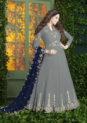 Simple And Elegant Looking, Designer Floor Length Suit Is Here In Grey Color Paired With Grey Colored Bottom And Navy Blue Colored Dupatta. Its Top And Dupatta Are Fabricated On Georgette Paired With Santoon Bottom. Its Pretty Color And Embroidery Will Earn You Lots Of Compliments From Onlookers. Buy Now.