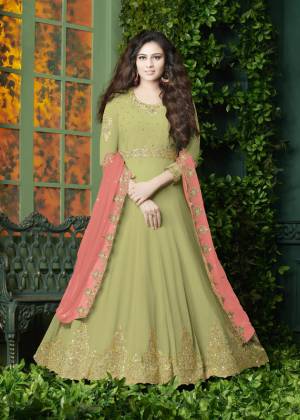 Flaunt Your Rich And Elegant Look Wearing This Designer Floor Length Suit In Light Green Color Paired With Light Green Colored Bottom And Peach Colored Dupatta. It Top Is Fabricated On Georgette Paired With Santoon Bottom And Georgette Dupatta. It Has Very Pretty Embroidery over The Top And Dupatta. Buy Now.
