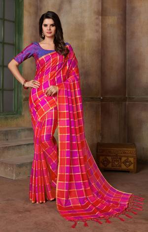 Shine Bright In This Dark Pink And Purple Colored Saree Paired With Purple Colored Blouse. This Saree And Blouse Are Silk Based Beautified With Checks Prints All Over It. 