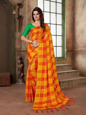 Shine Bright In This Yellow And Orange Colored Saree Paired With Green Colored Blouse. This Saree And Blouse Are Silk Based Beautified With Checks Prints All Over It. 