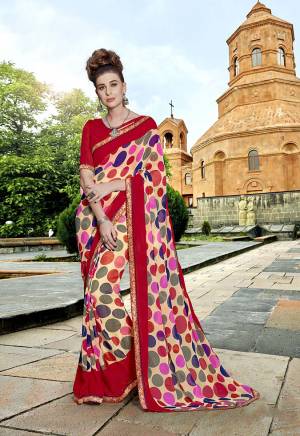 Go Colorful With This Pretty Saree In Multi And Red Color Paired With Red Colored Blouse. This Saree Is Fabricated On Georgette Beautified With Prints And Embroidered Lace Border Paired With Art Silk Fabricated Blouse. 