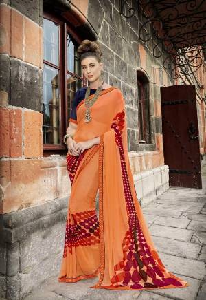 For Your Semi-Casual Wear, Grab This Pretty Saree In Orange Color Paired With Contrasting Navy Blue Colored Blouse. This Saree Is Fabricated On Georgette Paired With Art Silk Fabricated Blouse. 