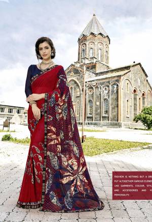 Here Is A Quite Attractive Looking Saree In Red Color Paired With Contrasting Navy Blue Colored Blouse. This Saree Is GeorgetteBased Paired With Art Silk Fabricated Blouse. It Is Light Weight And Durable. 