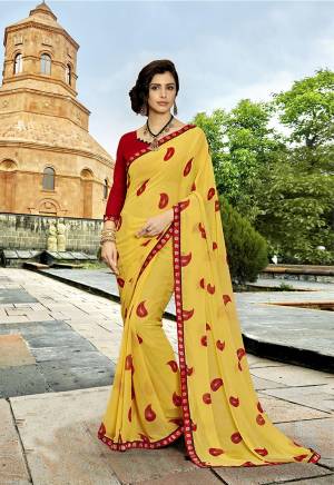For Your Semi-Casual Wear, Grab This Pretty Saree In Yellow  Color Paired With Contrasting Red Colored Blouse. This Saree Is Fabricated On Georgette Paired With Art Silk Fabricated Blouse. 