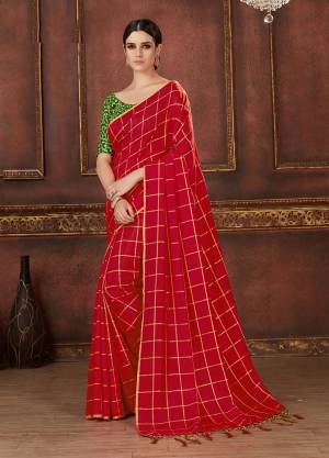 Adorn The Pretty Angelic Look In This Beautiful And Trendy Red Colored Checks Printed Saree Paired With Contrasting Dark Green Colored Blouse. It Is Fabricated On Silk Beautified With Prints, Embroidery And Tassels. 