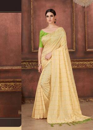 Simple, Elegant And Rich Looking Saree In Here In Cream Color Silk Based Beautified With Checks Prints Paired With Light Green colored Embroidered Blouse. It Is Comfortable And Easy To Carry All Day Long. 