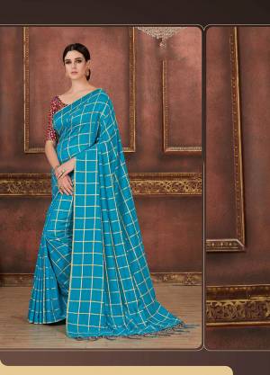 Celebrate This Festive Season Wearing This Beautiful Designer Checks Printed Saree In Turquoise Blue Color Paired With Wine Colored Blouse. This Saree And Blouse Are Silk Based Which Also Gives A Rich Look To Your Personality. 