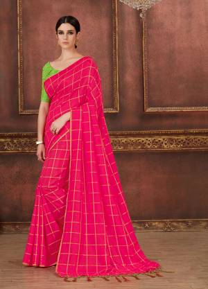 Adorn The Pretty Angelic Look In This Beautiful And Trendy Fuschia Pink Colored Checks Printed Saree Paired With Contrasting Parrot Green Colored Blouse. It Is Fabricated On Silk Beautified With Prints, Embroidery And Tassels. 