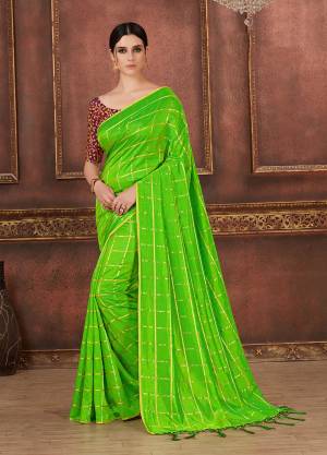 Simple, Elegant And Rich Looking Saree In Here In Green Color Silk Based Beautified With Checks Prints Paired With Wine colored Embroidered Blouse. It Is Comfortable And Easy To Carry All Day Long. 