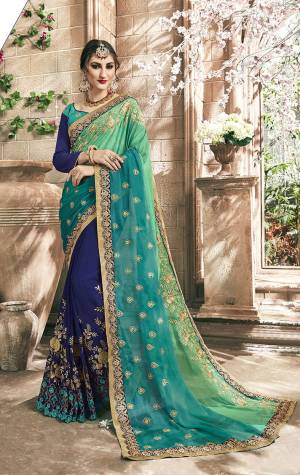 Go With The Shades Of Blue With This Designer Saree In Multiple Shades Of Blue Paired With Blue Colored Blouse. This Saree Is Fabricated On Chiffon And Georgette Paired With Art Silk Fabricated Blouse. It Is Beautified With Attractive Embroidery All Over. 