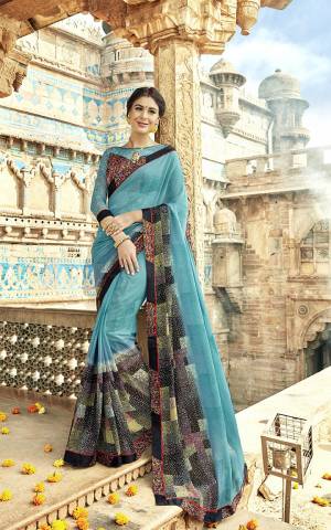 Here Is A Very Pretty And Elegant Looking Saree In Blue Color Paired With Multi Colored Blouse. This Saree Is Fabricated On Georgette Paired With Art Silk And Net Fabricated Blouse. It Is Light Weight And Easy To Drape. 