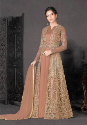 Add This Very Pretty Designer Indo-Western Suit to Your Wardrobe For The Upcoming Festive And Wedding Season. Its Top And Dupatta Are Net Based Which Comes With A Same Colored Silk Based Inner. It Is Beautified With Heavy Embroidery Making It More Attractive. 