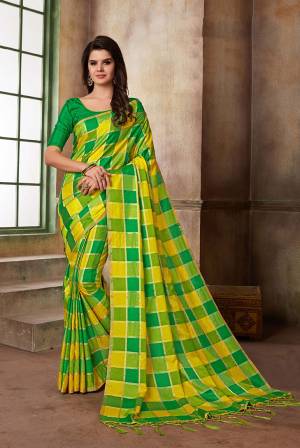 Celebrate This Festive Season With Beauty And Comfort Wearing This Saree In Yellow And Green Color Paired With Green Colored Blouse. This Saree And Blouse Are Fabricated On Art Silk Beautified With Checks Prints All Over. 