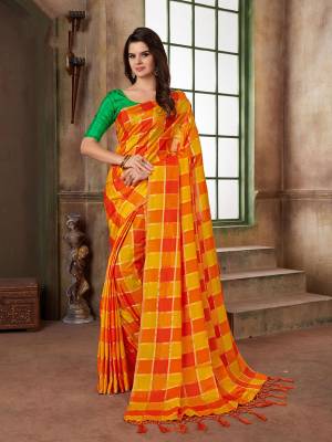 Shine Bright Wearing This Pretty Saree In Orange And Yellow Color Paired With Contrasting Green Colored Blouse, This Saree And Blouse Are Silk Based Beautified With Checks Prints All Over. 