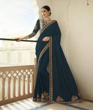 You Will Definitely Earn Lots Of Compliments Wearing This Lovely Color Pallet With Designer Saree In Peacock Blue Color Paired With Aqua And Peacock Blue Colored Blouse, This Saree And Blouse Are Soft Silk Based Beautified With Elegant Attractive Embroidery Over The Saree And Heavy Blouse. 