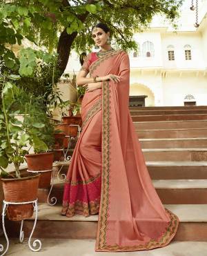 A Must Have Shade In Every Womens Wardrobe Is Here With This Designer Saree In Dark Peach Color Paired With Dark Peach And Pink Colored Blouse. This Saree And Blouse Are Silk Based Which Also Gives A Rich Look To Your Personality. 