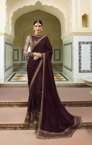 Here Is Saree Which Gives A Bold And Beautiful Look To Your Personality. Grab This Designer Saree In Wine Color Paired With Wine And Grey Colored Blouse. This Saree And Blouse Are Silk Based Beautified With Heavy Embroidery Over The Blouse And Saree Border. 