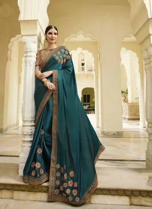 Rich And Elegant Looking Designer Saree Is Here In Teal Blue Color Paired with Beige Colored Blouse. This Saree And Blouse Are Silk Based Beautified With Elegant Embroidery over The Saree And Quite Heavy Blouse. 