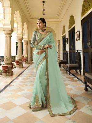 Subtle Shade Is Here With This Designer Saree In Aqua Blue Color Paired With Very Pretty Tint Of Mint Green Colored Blouse. This Saree Is Fabricated On Orgenza Paired With Silk Based Blouse. Buy This Designer Saree Now.