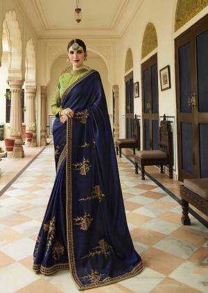 Enhance Your Personality Wearing This Designer Saree In Navy Blue Color Paired With Contrasting Green Colored Blouse. This Saree And Blouse Are Silk Based Beautified With Minimal Embroidery As The Color Of The Saree Is Quite Loud. 