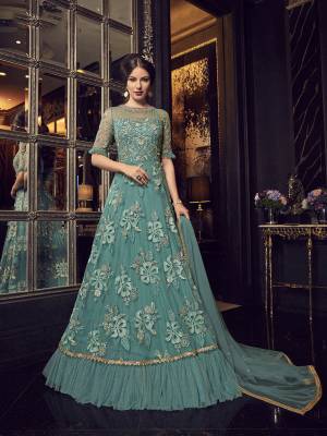 Rich And Heavy Designer Floor Length Suit Is Here In Turquoise Blue Color Paired With Turquoise Blue Colored Bottom And Dupatta. Its Top And Dupatta Are Fabricated On Net Paired With Santoon Bottom. All Its Fabrics Ensures Superb Comfort Throughout The Gala.