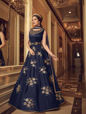 Enhance Your Personality In This Beautiful Designer Floor Length Suit In Navy Blue Color. Its Heavy Embroidered Top Is Fabricated On Art Silk Paired With Santoon Bottom And Net Fabricated Dupatta. Get This Altered As per Your Desired Fit And Comfort. 