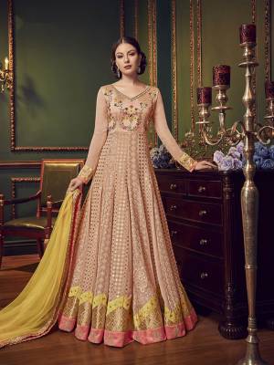 Look Very Pretty In This Beautiful Designer Floor Length Suit In Peach Color Paired With Contrasting Yellow Colored Dupatta. Its Top Is Fabricated On Georgette Paired With Santoon Bottom And Net Dupatta. It Is Beautified With Very Pretty Tone To Tone Embroidery.