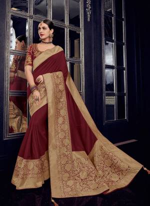 Bring out the best in you when wearing this maroon and gold color silk fabric with rich jacquard pallu saree. Ideal for party, festive & social gatherings. this gorgeous saree featuring a beautiful mix of designs. Its attractive color and designer heavy design, stone design, silk fabric with rich jacquard pallu and beautiful design all over work over the attire & contrast hemline adds to the look. Comes along with a contrast unstitched blouse.