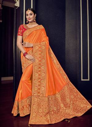 Vibrant and visually appealing, this Orange and gold color silk fabric with rich jacquard pallu saree. Ideal for party, festive & social gatherings. this gorgeous saree featuring a beautiful mix of designs. Its attractive color and designer heavy design, stone design, silk fabric with rich jacquard pallu and beautiful design all over work over the attire & contrast hemline adds to the look. Comes along with a contrast unstitched blouse.