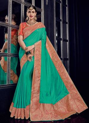 Look your ethnic best by wearing this Sea green and gold color silk fabric with rich jacquard pallu saree. Ideal for party, festive & social gatherings. this gorgeous saree featuring a beautiful mix of designs. Its attractive color and designer heavy design, stone design, silk fabric with rich jacquard pallu and beautiful design all over work over the attire & contrast hemline adds to the look. Comes along with a contrast unstitched blouse.
