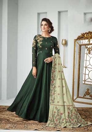 Go With The Shades Of Green With This Designer Floor Length Suit In Dark Green Color Paired With Pastel Green Colored Dupatta, Its Top Is Fabricated On Satin Georgette Paired With Santoon Bottom And Art Silk Dupatta. It Is Light In Weight And Easy To Carry All Day Long. 