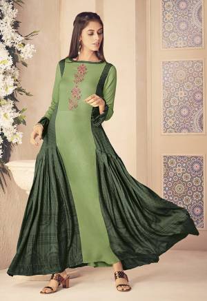 Go With The Shades Of Green Wearing This Designer Readymade Kurti In Light Green And Dark Green Color Fabricated On Rayon. It Is Beautified With Prints And Attractive Thread Work. Buy Now.