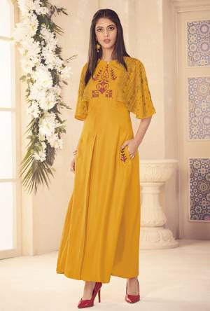 Celebrate This Festive Season Wearing This Designer Readymade Long Kurti In Yellow Color Fabricated On Rayon. This Kurti Is Beautified With Prints And Thread Work. Its Color And Fabric Will Earn You Lots Of Compliments From Onlookers. 