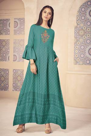 Celebrate This Festive Season Wearing This Designer Readymade Long Kurti In Turquoise Blue Color Fabricated On Rayon. This Kurti Is Beautified With Prints And Thread Work. Its Color And Fabric Will Earn You Lots Of Compliments From Onlookers. 