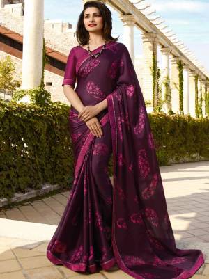 You Will Definitely Earn Lots Of Compliments Wearing This Pretty Saree In Wine Color Paired With Wine Colored Blouse. This Saree Is Fabricated On Georgette Paired With Art Silk Fabricated Blouse. It Is Beautified With Prints All Over. 