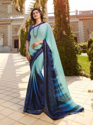 Go with The Shades Of Blue With This Printed Saree In Aqua Blue Color Paired With Navy Blue Colored Blouse. This Saree Is Georgette Based Paired With Art Silk Fabricated Blouse. It Has Panel Printing Giving It An Unique Look. 